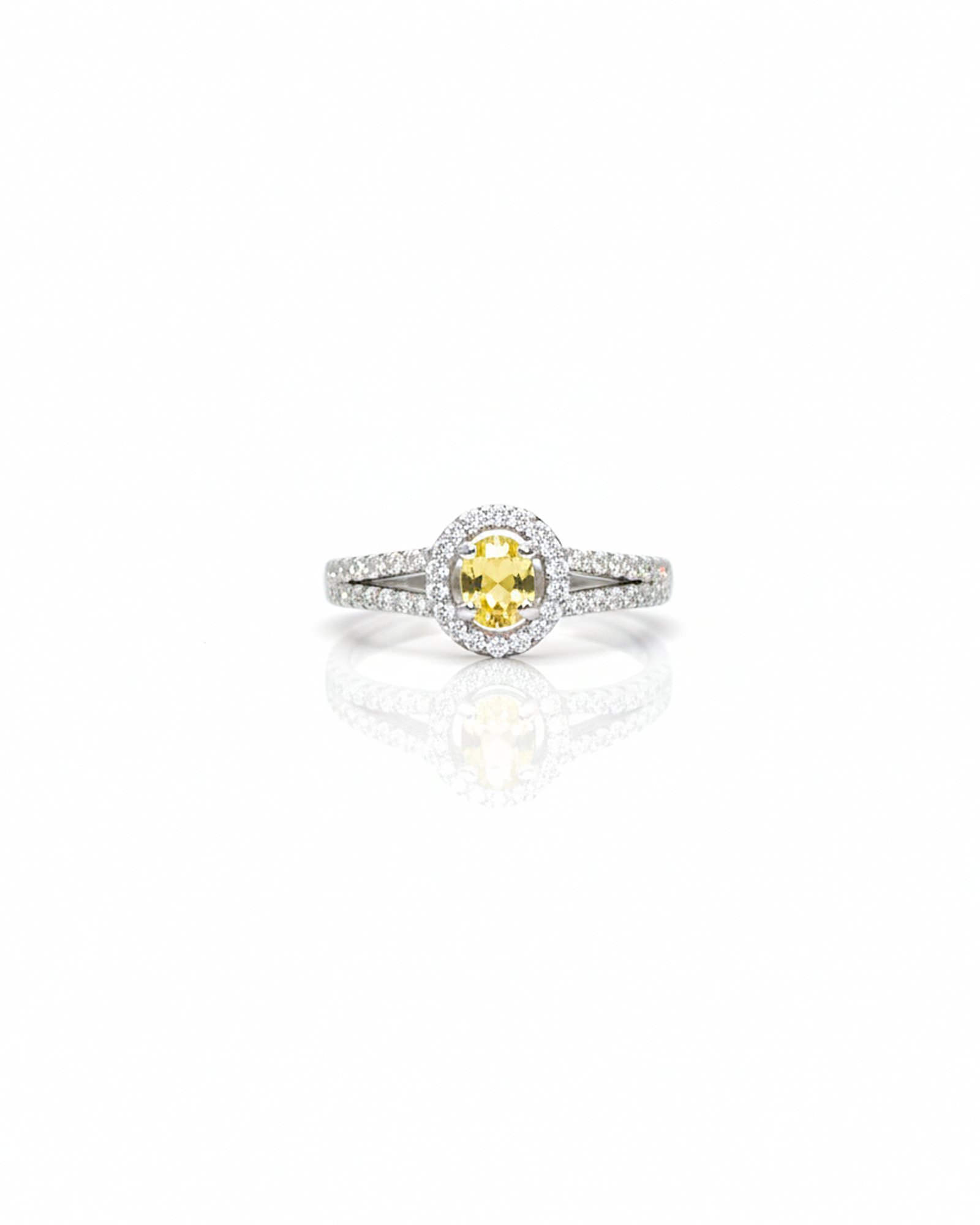 Front view of 925 silver yellow sapphire halo ring with oval gemstone and American diamonds on split shank design