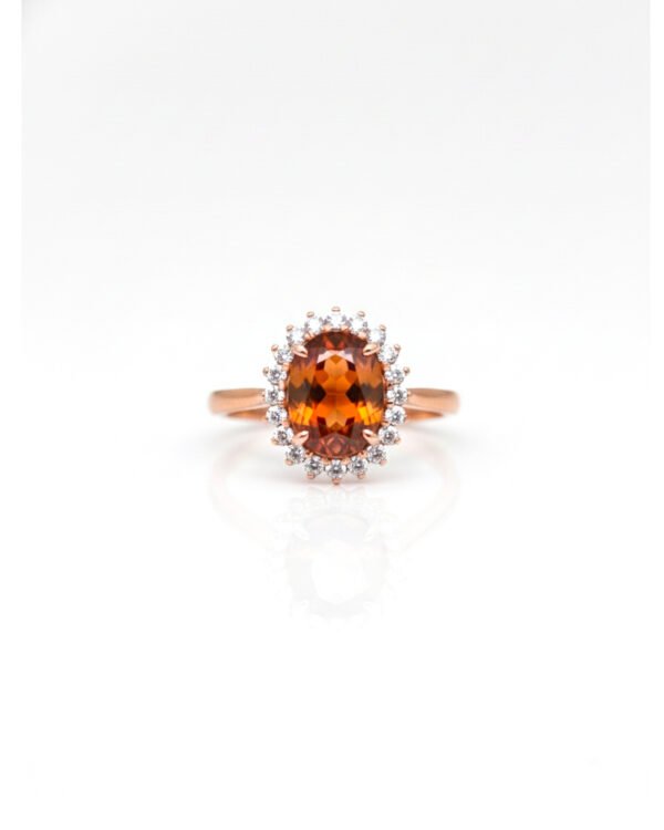 Front view of rose gold adjustable Hessonite Garnet halo ring with American Diamonds