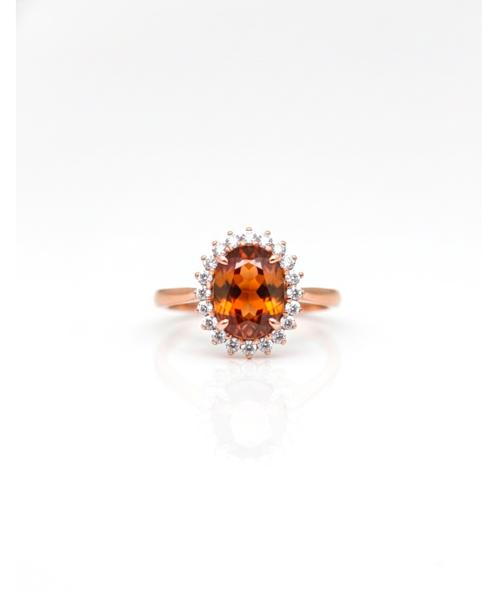 Front view of rose gold adjustable Hessonite Garnet halo ring with American Diamonds
