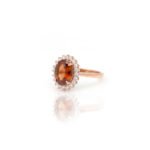 Side view of rose gold Hessonite Garnet halo ring with American Diamonds