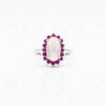 Front view of 925 sterling silver blue moonstone and ruby cluster ring with oval-cut moonstone and ruby halo