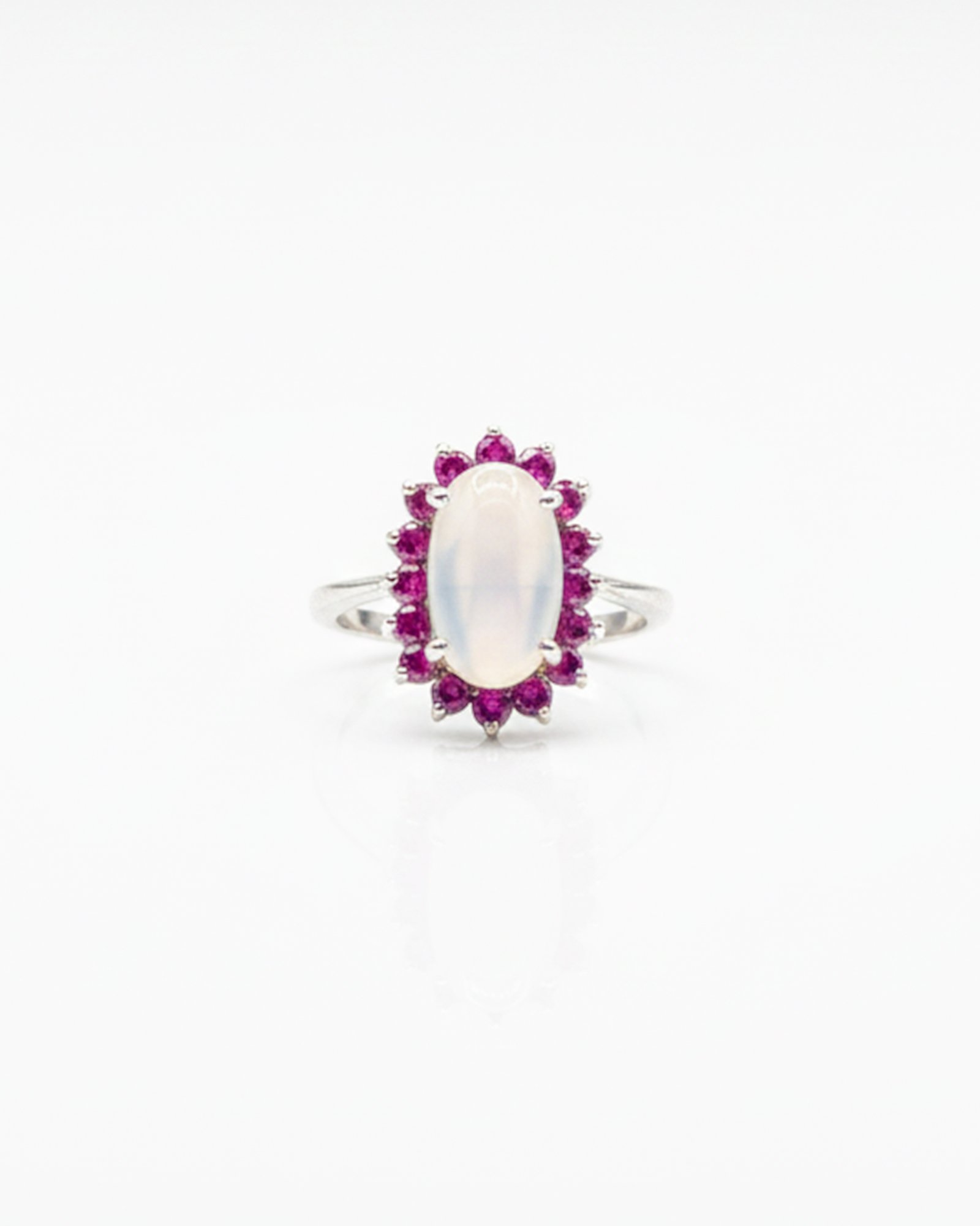 Front view of 925 sterling silver blue moonstone and ruby cluster ring with oval-cut moonstone and ruby halo